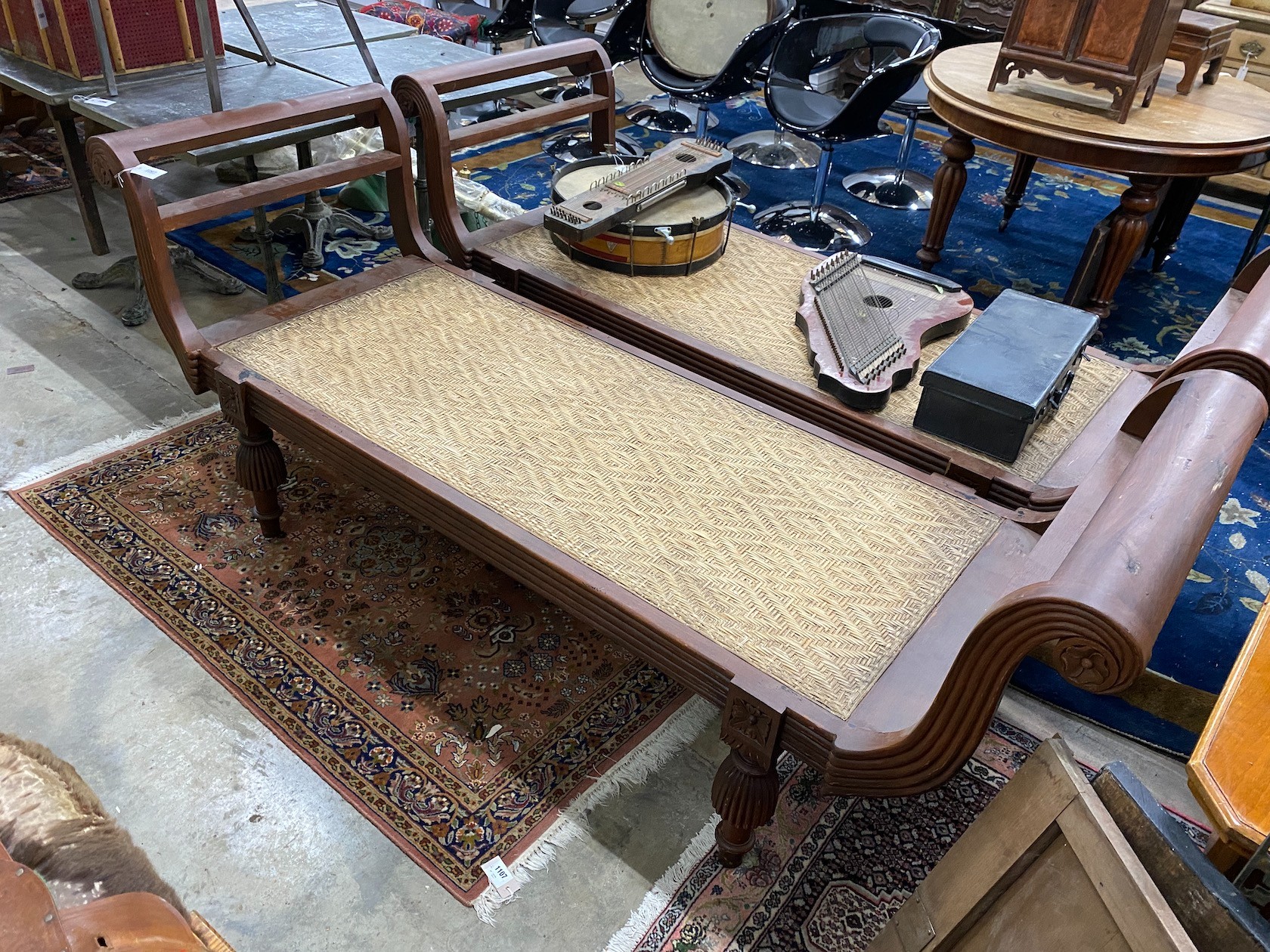 An Asian hardwood day bed with cane seat, length 210cm